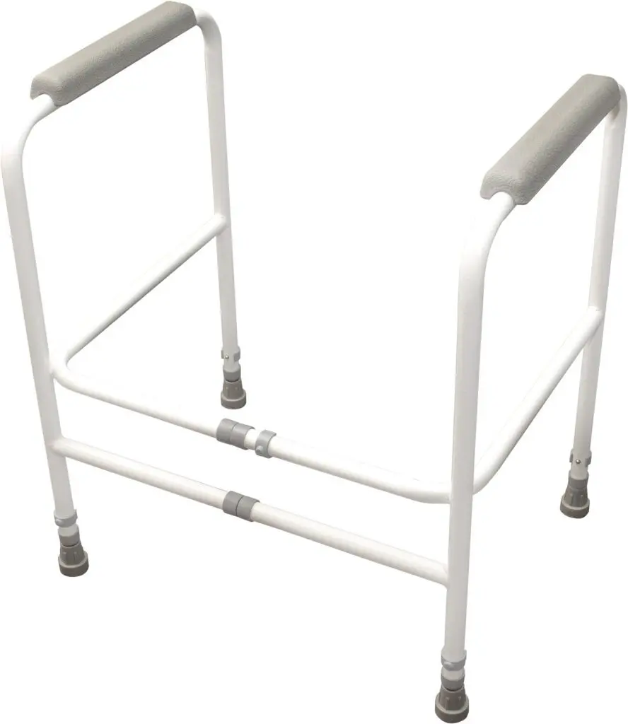 The Broadstairs Toilet Frame with Adjustable Height and Width features a white metal safety frame with padded armrests, designed to assist users with sitting and standing when placed around a toilet.