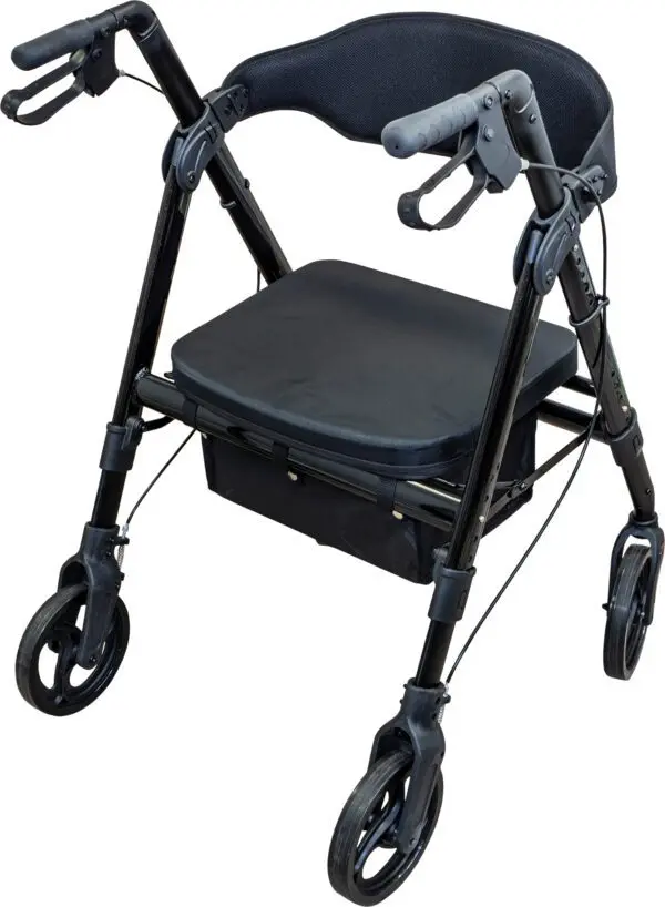 The Deluxe Bariatric Rollator is a black mobility walker featuring four wheels, a padded seat, backrest, hand brakes, and an under-seat storage pouch.