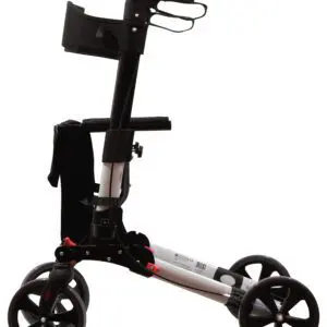 The Deluxe Fold Flat Rollator, in black and silver, features four wheels, a seat, storage pouch, and hand brakes. It is shown from the side against a white background.