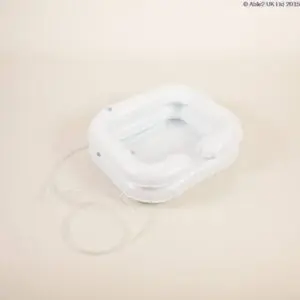 The ATLANTIS DELUXE INFLATABLE SHAMPOO RING is a white plastic basin with a drainage tube, designed for washing hair or other hygiene needs in bed.