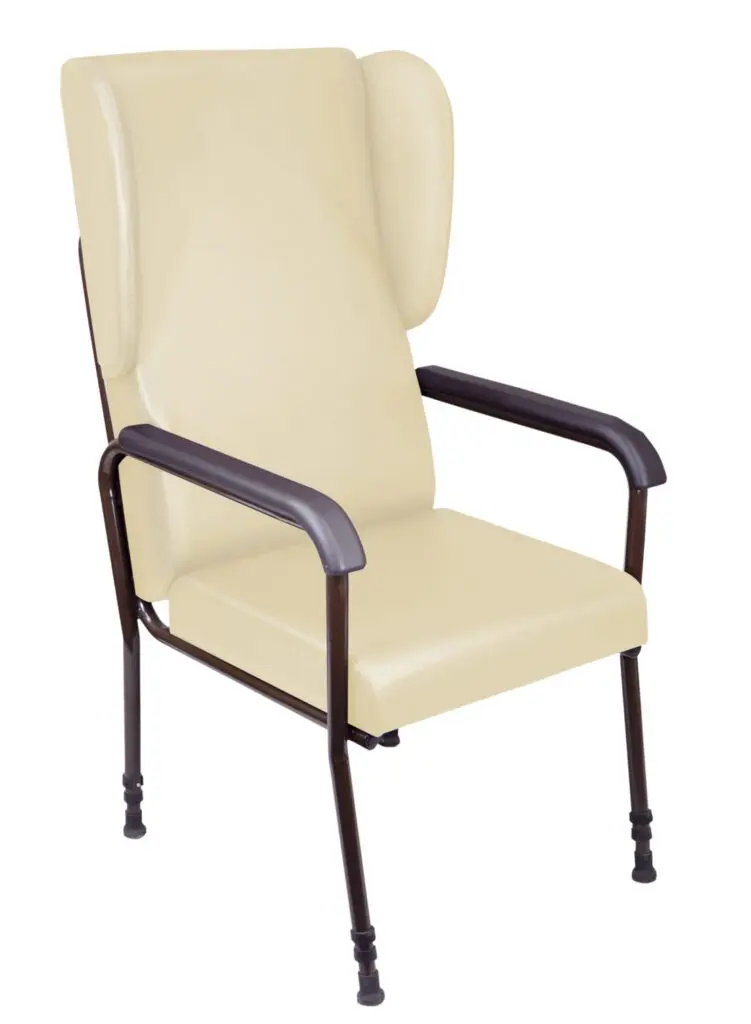 The Chelsfield Height Adjustable Chair is beige with a high back, winged sides, metal armrests, and four sturdy legs fitted with rubber tips.