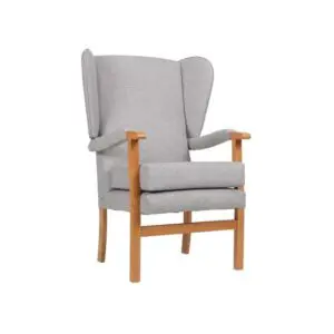 The Jubilee Fireside Chair is a grey upholstered wingback armchair with wooden legs and armrests, shown against a plain white background.