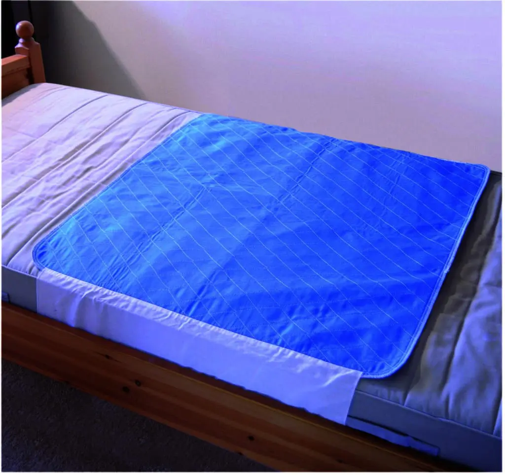 A Washable Bed Pad is laid on the mattress, partially covering the bed in a tidy room.
