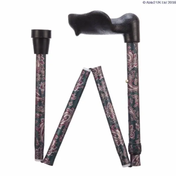 The ARTHRITIS GRIP WALKING STICK - FOLDING, ADJUSTABLE PAISLEY features a paisley pattern, a black ergonomic handle, and folds into four segments for easy storage.