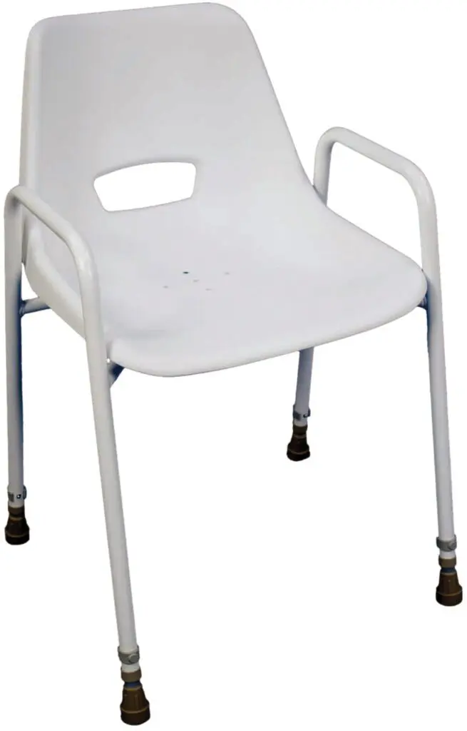 Milton Stackable Portable Shower Chair: White plastic chair with armrests and metal legs, each leg featuring a brown rubber tip.
