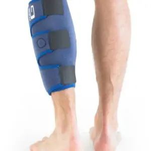 A person is seen from behind wearing the NEO G CALF/SHIN SPLINT SUPPORT, a blue neoprene brace with three adjustable straps on their lower leg.