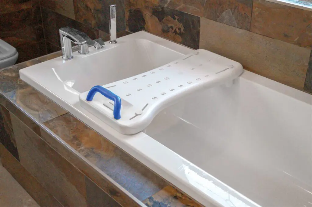 The Width Adjustable Bath Board with Integral Handle is placed across the bath to support safe entry and exit.