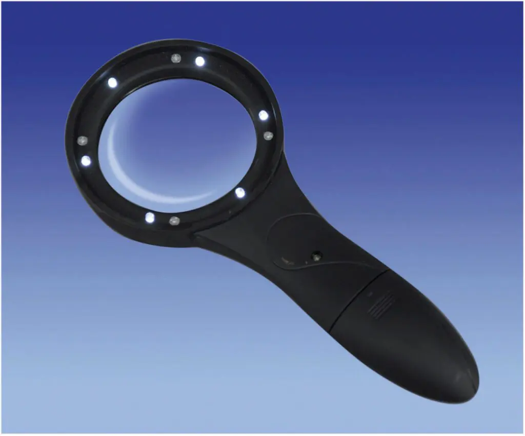 The Deluxe Comfort Grip Magnifier with 6 LED Lights is a black handheld magnifier featuring built-in LEDs around the lens, displayed against a blue gradient background.