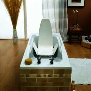 A modern bathroom with a bath featuring the Neptune Bathlift in white, a sponge on the bath edge, toiletries on the floor, and decorative items with a framed picture in the background.