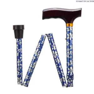 The FOLDING ADJUSTABLE WALKING STICK is blue with a white floral pattern, features a black handle and rubber tip, and can be shown both unfolded and folded.