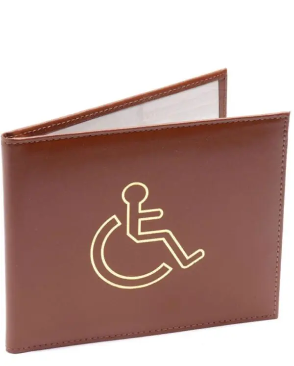 A brown wallet with a gold accessibility symbol featuring a person in a wheelchair on the front.