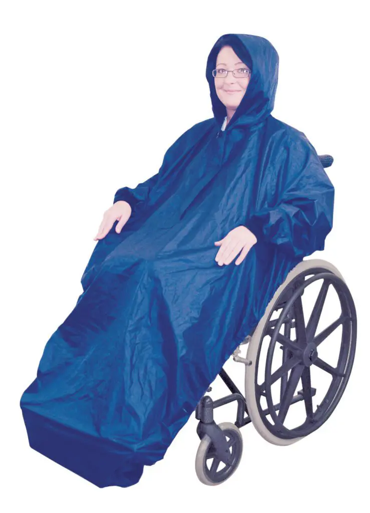 A person in a wheelchair wears the Fleece Lined Wheelchair Mac with Sleeves, a blue poncho covering both their body and wheelchair, against a white background.