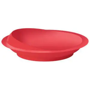 A red, oval-shaped plastic plate with a slightly raised, angled edge.