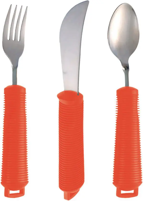 The Bendable Cutlery Set (6 piece) in red features a fork, knife, and spoon with wide, textured handles arranged upright against a white background.