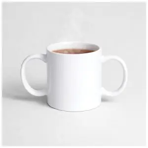 A white mug with two handles, filled with a hot beverage, sits on a plain white surface. Steam rises from the cup.