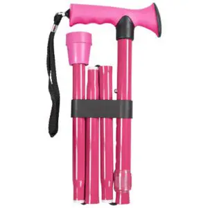 A pink folding walking stick with a curved handle, black wrist strap, and rubber tip, held together by a black band.
