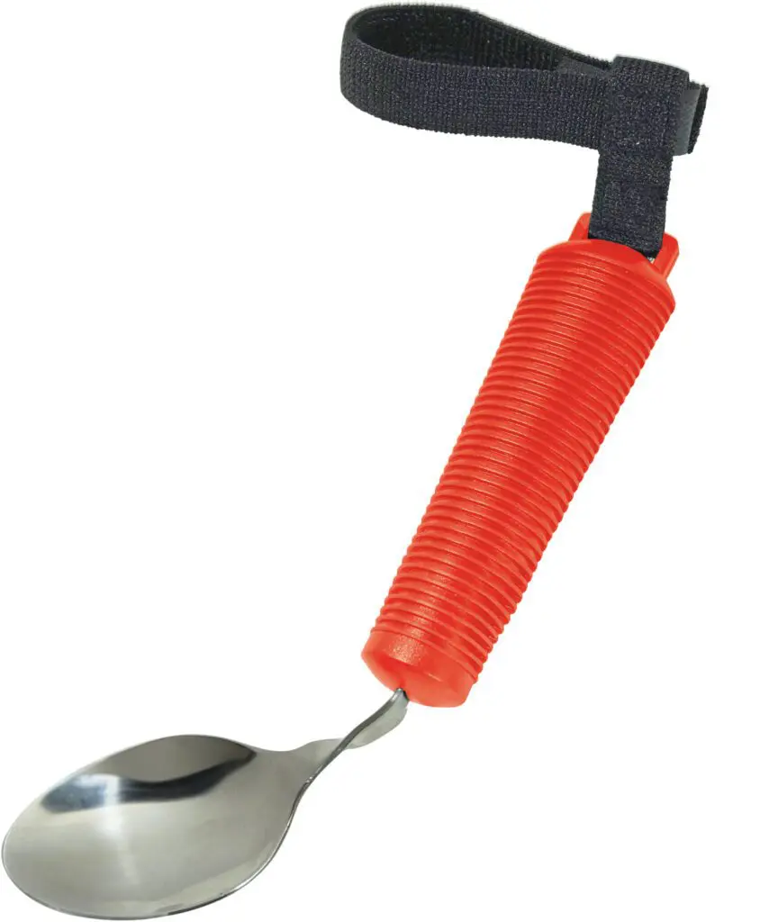 The Bendable Cutlery Set (6 piece) - Red features a spoon with a red ribbed handle and black adjustable strap for improved grip and control.