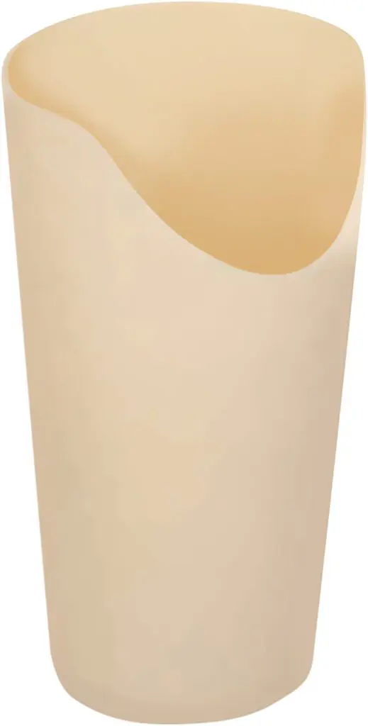 The Nose Cut Out Cup - Cream is a beige, smooth plastic cup with an asymmetrical, slanted rim, displayed against a white background.