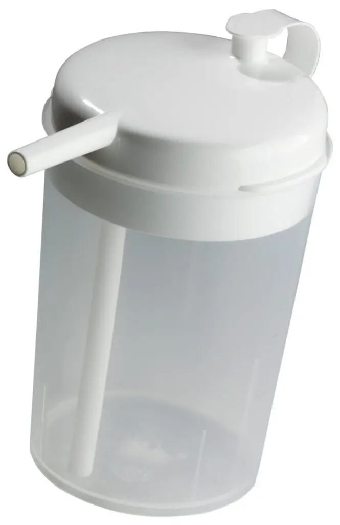 The Novo Cup is a clear plastic cup with a white lid and built-in straw, designed for easy drinking and commonly used in medical or care settings.
