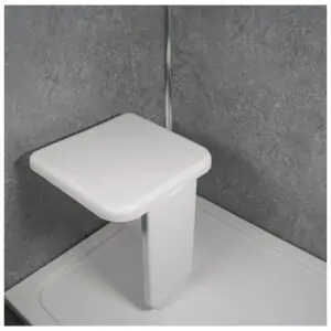 The Folding Shower Seat with Leg is wall-mounted and folds down for use inside a grey-tiled shower cubicle.