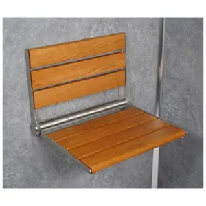 The Wooden Slatted Shower Seat in Oak features a wall-mounted, folding design with a sturdy metal frame, shown attached to a grey tiled wall.