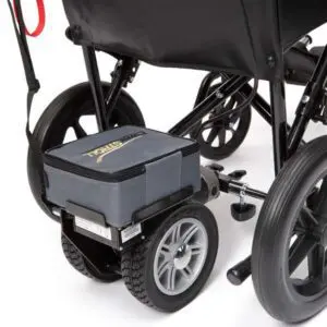 A close-up view of the rear wheels and motor of a wheelchair, featuring a grey Lightweight Powerstroll motorised attachment connected to the frame.
