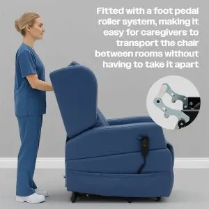 A carer in scrubs stands behind the Barrowfield Rise and Recline Chair, featuring a blue design and a foot pedal castor system for easy mobility between rooms.