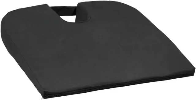 The Coccyx Wedge Cushion is a black, wedge-shaped seat cushion featuring a U-shaped cut-out and a handle at the back.