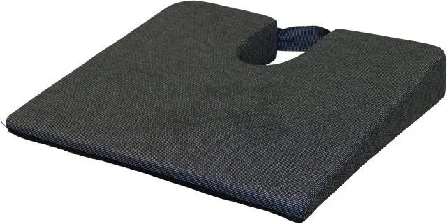 The Coccyx Wedge Cushion is a black, wedge-shaped seat cushion with a U-shaped cut-out and a handle on the back.