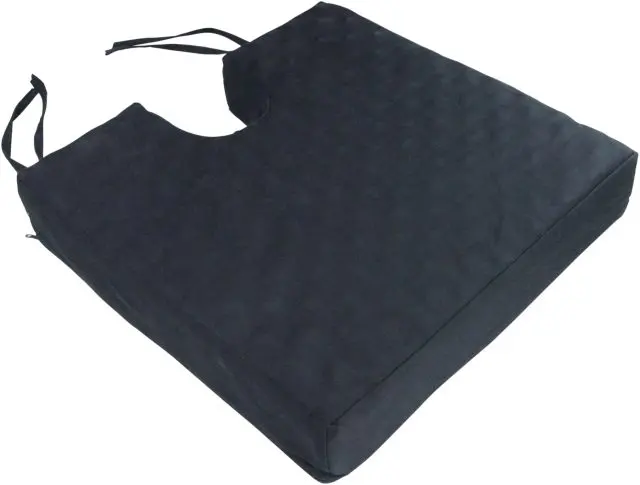 The Deluxe Pressure Relief Orthopaedic Coccyx Cushion is a black rectangular foam cushion with a coccyx cut-out, textured surface, and attached straps for secure wheelchair placement.