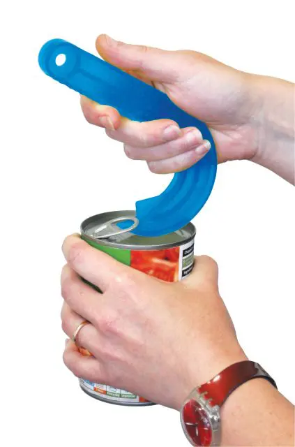 Two hands use the Ring Pull Can Opener, a blue plastic tool, to open the pull-ring of a metal tin against a white background.