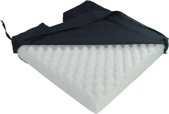 The Deluxe Pressure Relief Orthopaedic Coccyx Cushion features a wedge-shaped, egg crate foam design and a black fabric cover that's partially unzipped and pulled back.