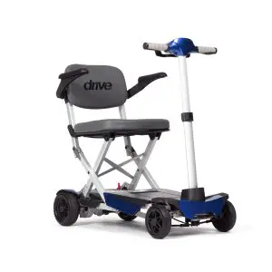 A compact, foldable mobility scooter with four wheels, a padded seat, armrests, and handlebar controls on a white background.