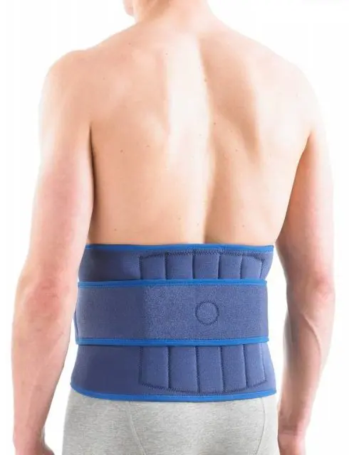 A person shown from the back wears a Neo G Back Brace with Stays, a blue lumbar support belt, wrapped around their lower torso over grey trousers.