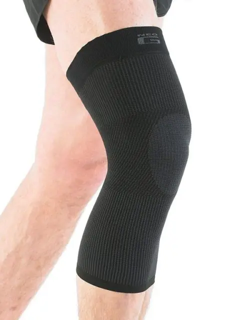 A person wearing a black knee support on their left leg, shown from mid-thigh to mid-calf against a white background.