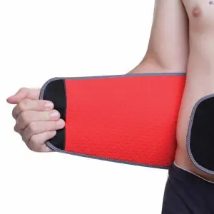 A person wearing the Aero-Tech Neoprene Advanced Back Support - Universal, fastening it around their waist with one hand, against a white background.