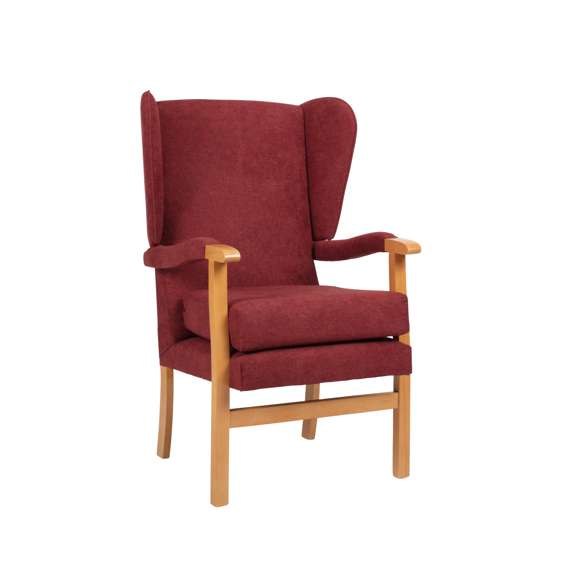 A wooden-framed chair with red upholstered seat, backrest, and armrests, featuring a high back and winged sides.