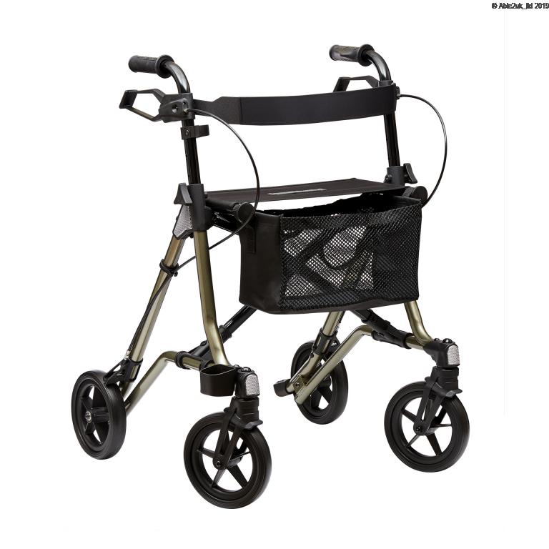 Four-wheeled rollator walker with black handles, hand brakes, a padded seat, mesh storage basket, and large black wheels on a champagne-coloured frame.
