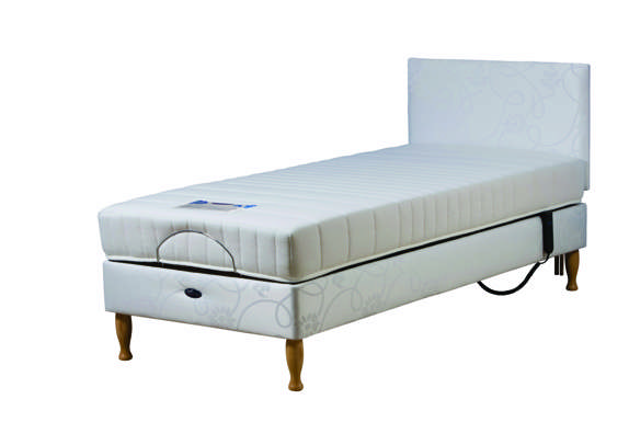 Single adjustable bed with a white mattress, headboard, and wooden legs, featuring a side mechanism for height or angle adjustment.