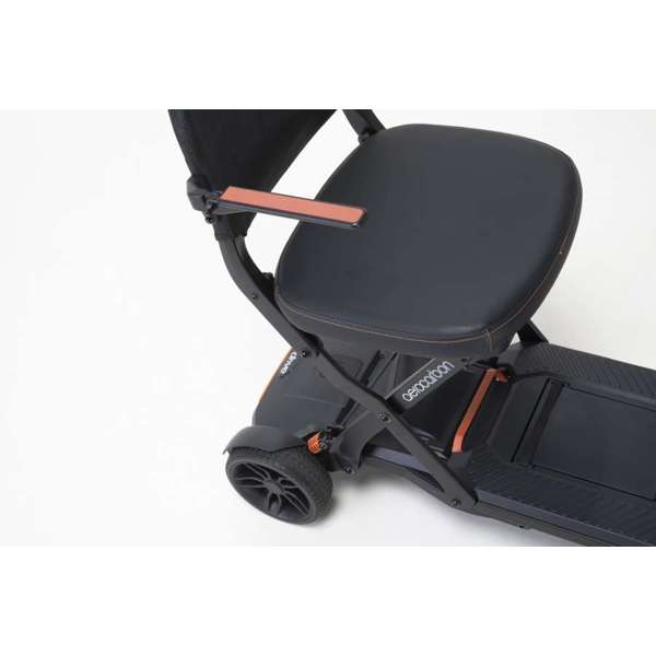 Compact mobility scooter with a black seat, armrests, and two rear wheels, shown on a white background.