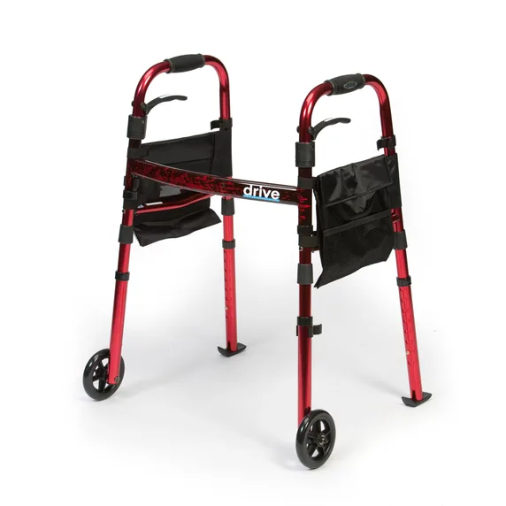 The Ready Set Go Travel Walker, featuring a red folding frame, two front wheels, black hand grips, and side storage pouches, is shown standing on a white background.
