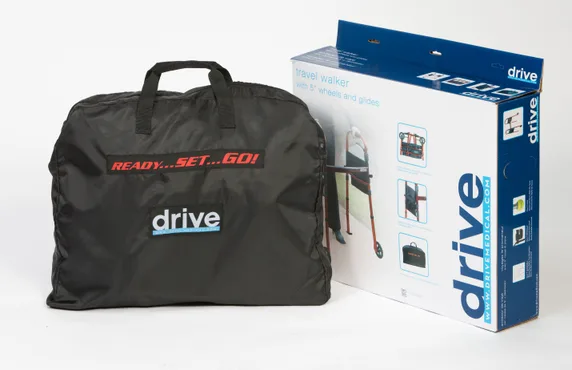 A black Ready Set Go Travel Walker carrying bag is shown next to its product box, which features images and product information about the walking frame.